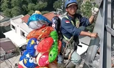 Petugas PLN Panjat Tower SUTET Demi Evakuasi Balon Pedagang, Warganet Malah Salfok